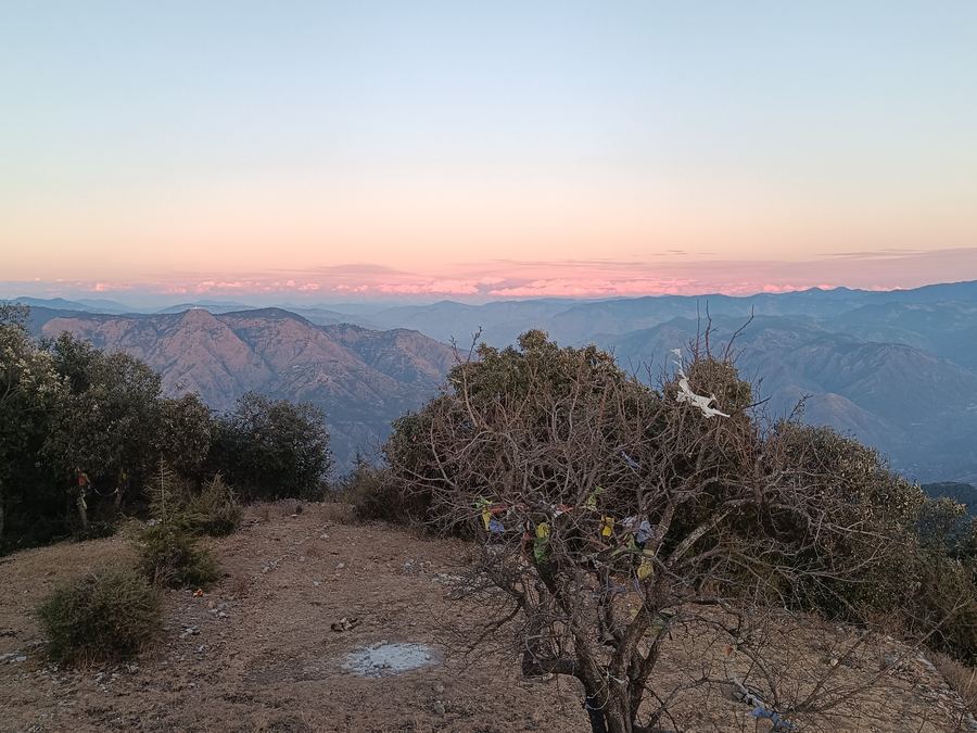 Pink sunset sky over layered ranges from the fort summit