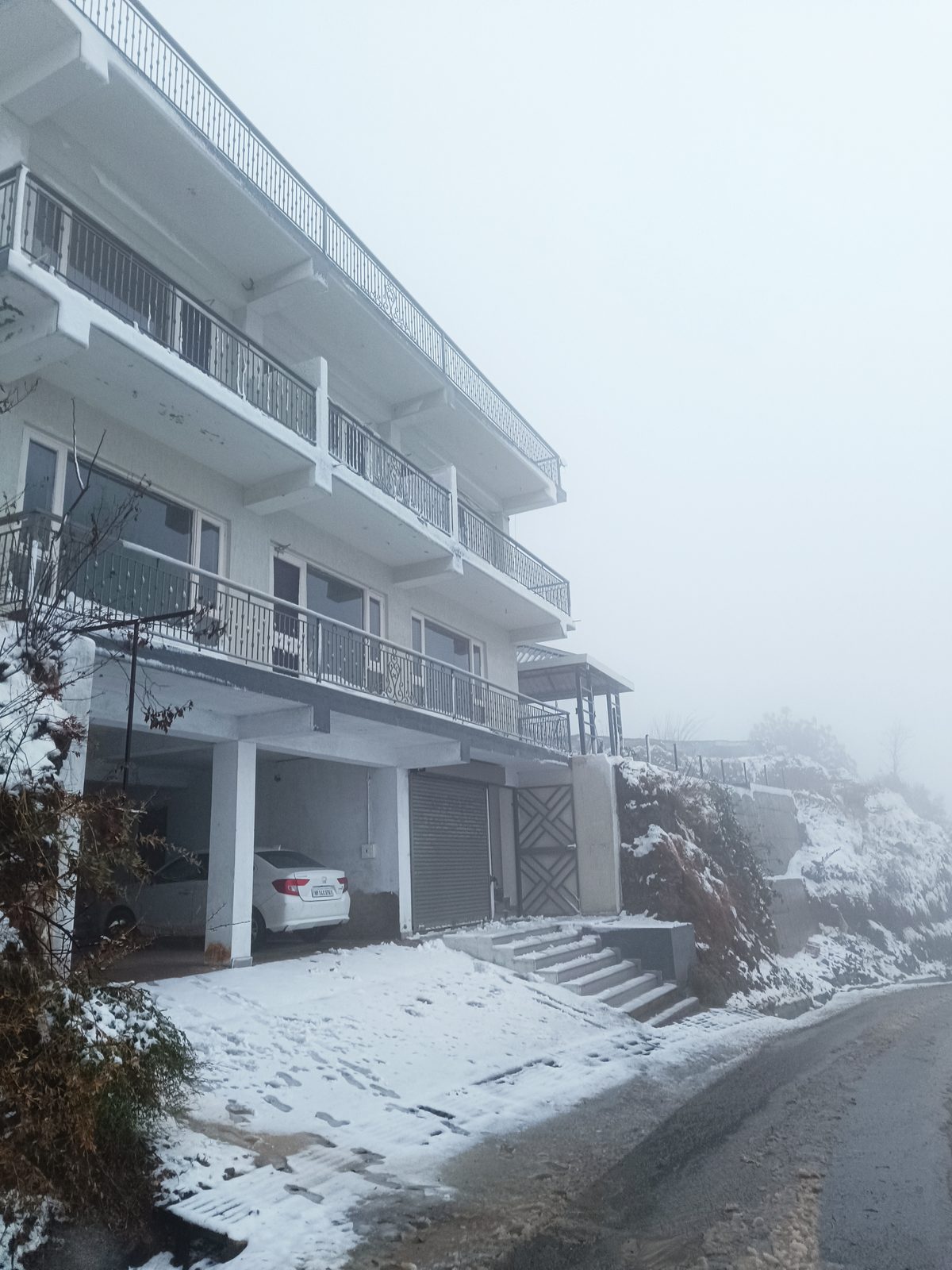 Windmill Inn under a fresh layer of snow — balconies and terraces on a misty morning