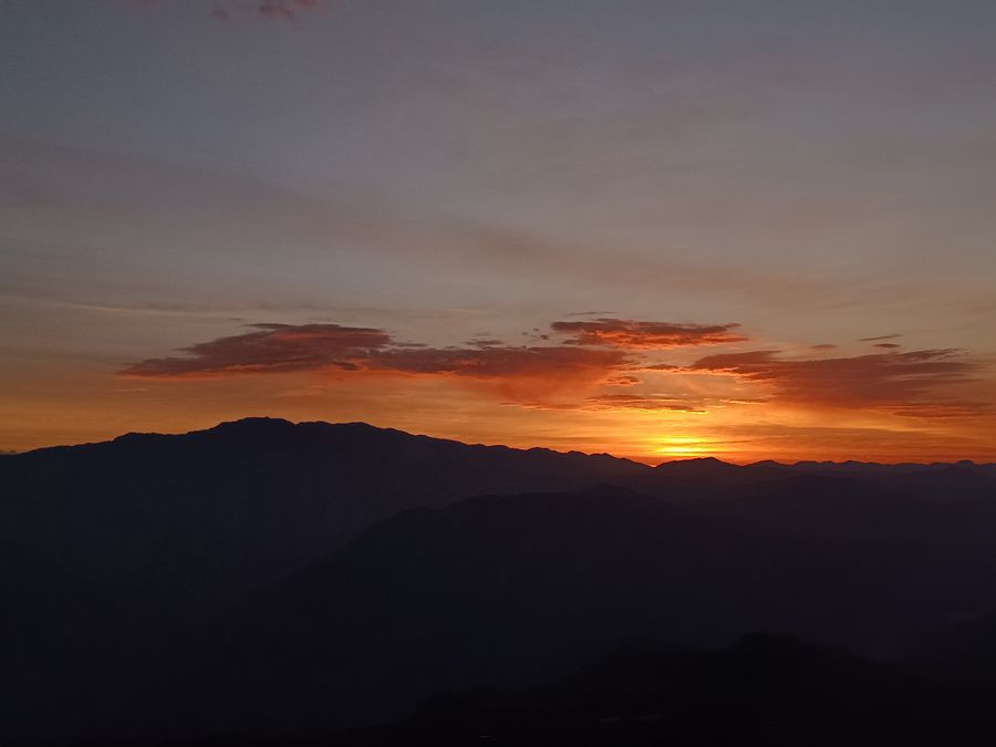 Orange sunset over layered mountains